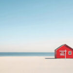 Red beach house with “For Rent” sign symbolizing slow rental market growth