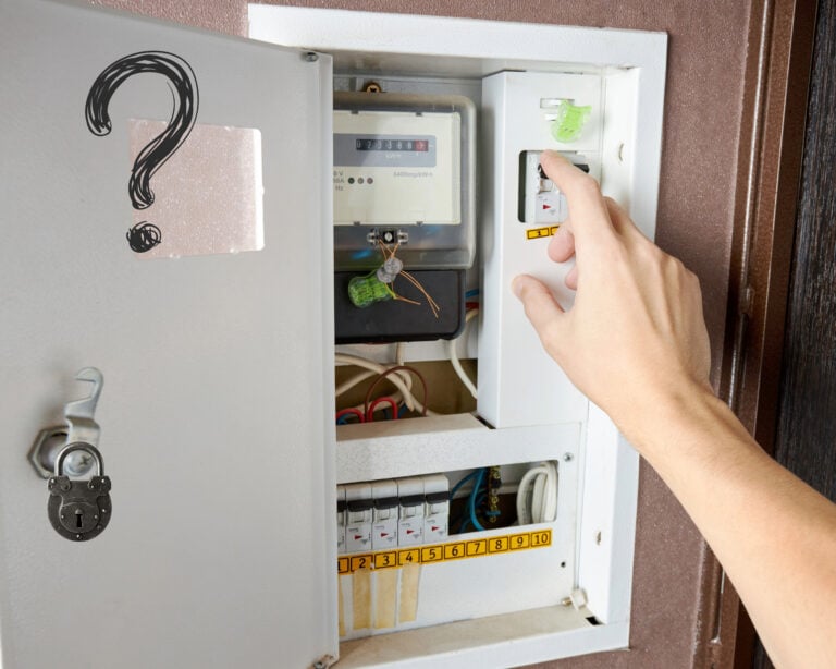 Hand operating circuit breaker in communal electric meter cupboard with padlock and question mark symbol.