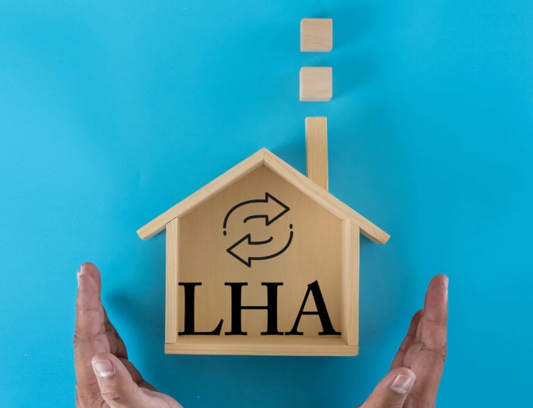 Wooden house model with LHA letters symbolising Local Housing Allowance and rent support reform.