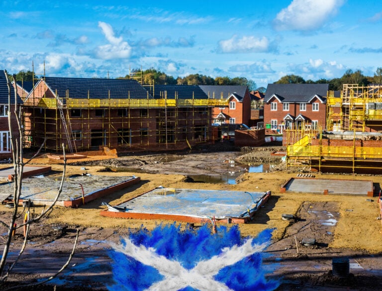 New housing development under construction in Scotland with foundations and scaffolding visible