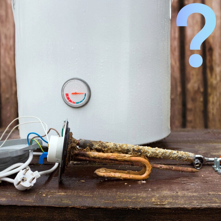 Corroded water heater element beside boiler with temperature gauge