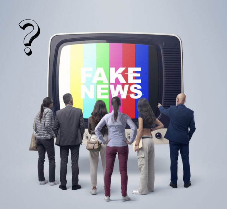 Group standing before a TV displaying “Fake News” to illustrate media bias in housing policy debate