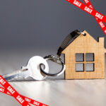 House key and wooden home keychain symbolising landlords selling properties amid new rental laws