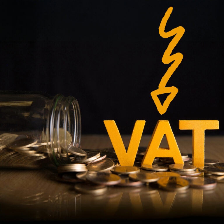 Coins spilling from jar beside VAT lettering to illustrate small-business VAT threshold impact