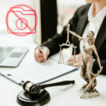 Lawyer with gavel and Lady Justice beside warning icon symbolising missing rent appeal tribunal data