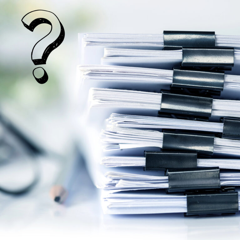Stack of legal documents with binder clips and a question mark symbol beside them.