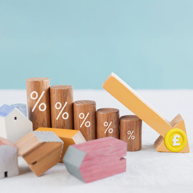 Falling UK house prices illustrated with wooden houses, percentage markers and a downward arrow