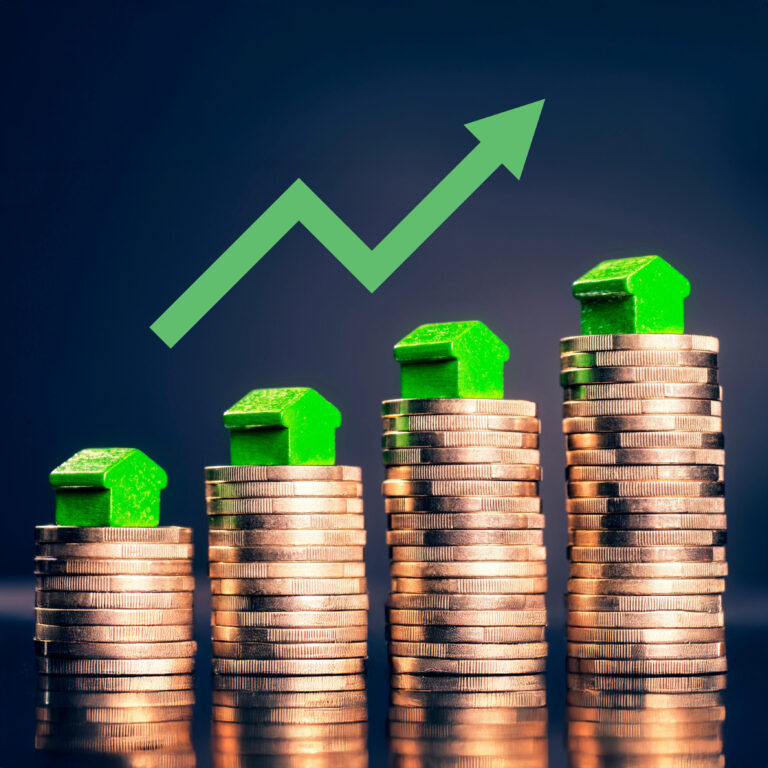 Stacked coins with green houses and upward arrow symbolizing rising UK house prices