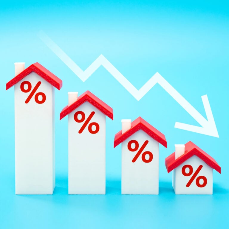Falling mortgage rate concept with houses and downward arrow