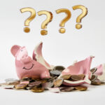 Broken piggy bank with scattered coins symbolising landlord uncertainty over deposit rules