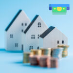 Model houses with stacked coins illustrating the Mansion Tax