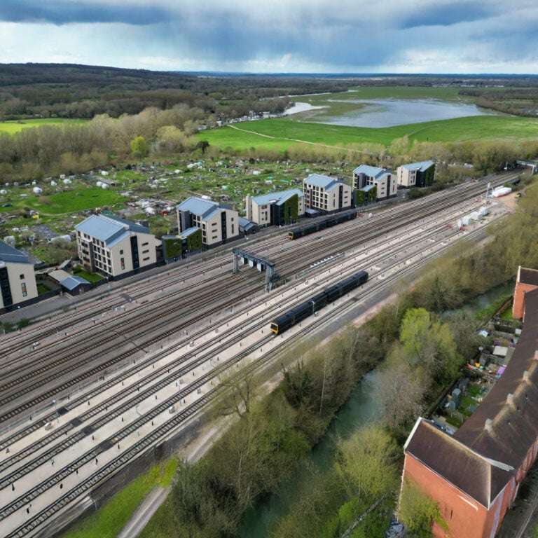 New housing beside railway lines demonstrating plans for development near well-connected train stations