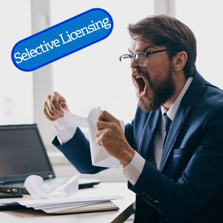 Angry landlord tearing paperwork while reacting to selective licensing concerns