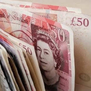 stack of £50 notes symbolising fast cash for landlords selling before new regulations