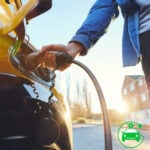 Homeowner plugging an electric car into a private EV charging point outside a London home