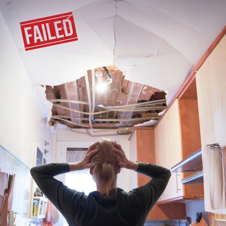 Collapsed ceiling exposing beams above a child’s bed in a social housing property marked as failed
