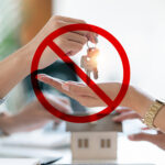 Social housing application rejected, symbolised by house keys blocked by a prohibition sign