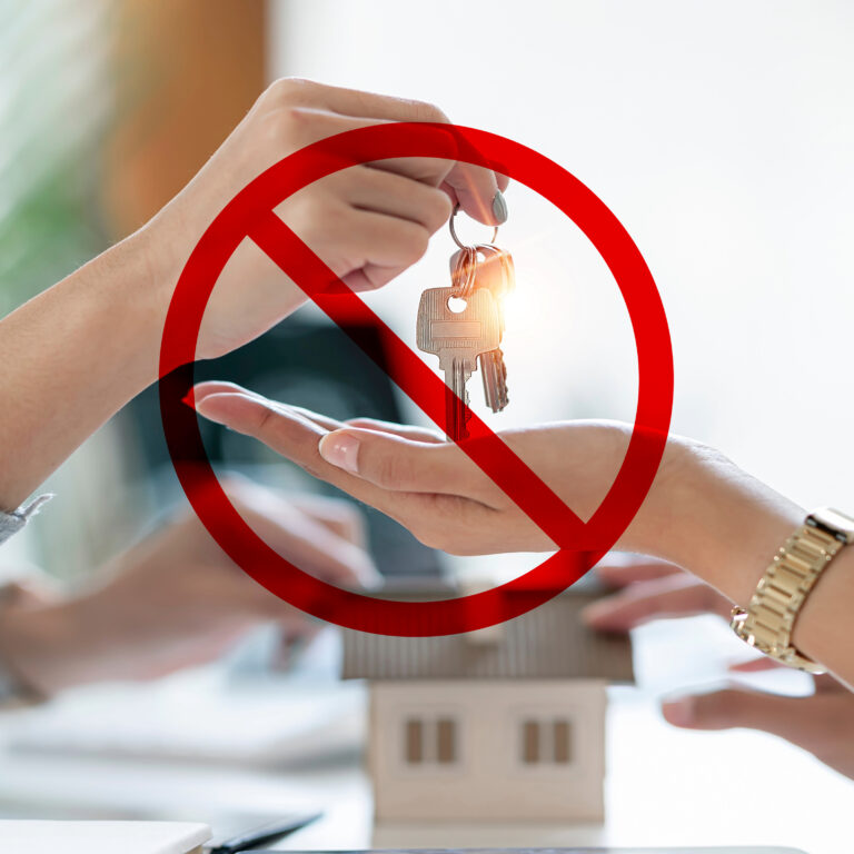 Social housing application rejected, symbolised by house keys blocked by a prohibition sign