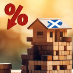 Falling housebuilding in Scotland shown by a percentage drop and a house with the Scottish flag