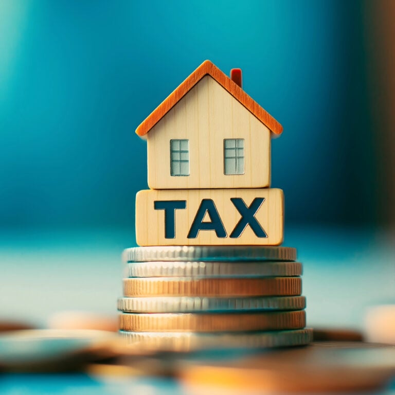 House model on stacked coins illustrating rising landlord tax pressures