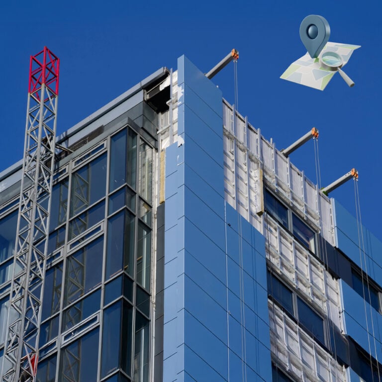 High-rise building with external cladding partially removed during safety inspection and remediation monitoring