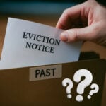 Eviction notice placed in a file marked “Past,” symbolising landlord decisions on serving Section 21 notices