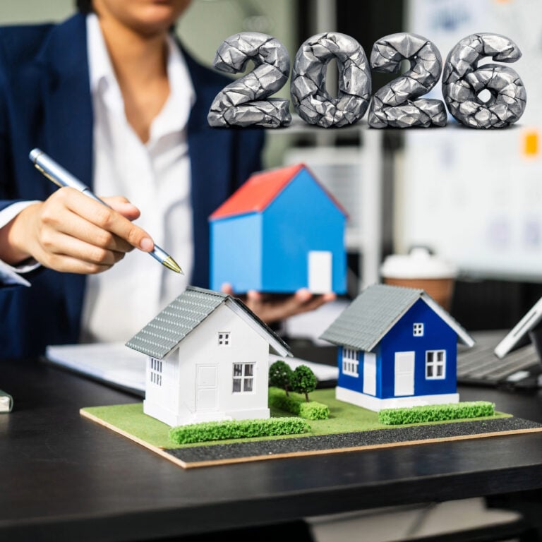 Estate agent reviewing miniature houses as 2026 regulations and costs reshape the UK property market