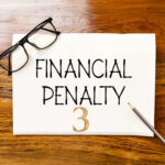 Financial penalty notice with glasses and pencil, illustrating council enforcement action against unlicensed rental properties