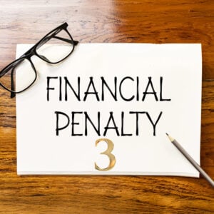 Financial penalty notice with glasses and pencil, illustrating council enforcement action against unlicensed rental properties