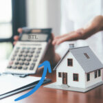 Buy-to-let mortgage calculator beside model house illustrating UK rental property lending