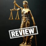 Lady Justice statue with scales and a bold “Review” stamp symbolising a legal challenge to housing regulation in Leeds