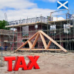 Construction site in Scotland with scaffolding and large red tax lettering highlighting proposed housebuilding levy