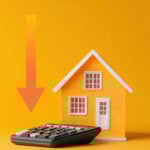Model house beside a calculator with a downward arrow symbolising falling UK rental prices