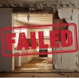 Failed inspection stamp over a damaged social housing kitchen with signs of damp, decay and disrepair.