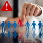 Hand removing a red figure from a line of blue figures, symbolising tenant discrimination risks