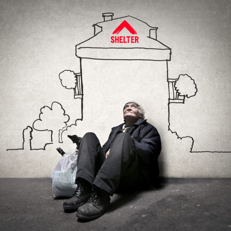 Older man sitting beneath a sketched house marked Shelter, symbolising homelessness and the housing crisis