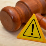 Judge’s gavel beside a warning sign symbolising legal challenge over selective licensing scheme