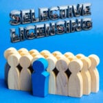 Wooden figures symbolising private renters with selective licensing text above