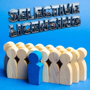 Wooden figures symbolising private renters with selective licensing text above