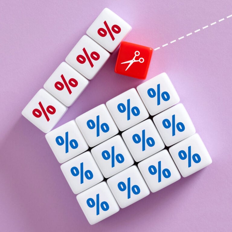 Red percentage blocks being cut away from blue blocks, symbolising buy-to-let mortgage rate reductions