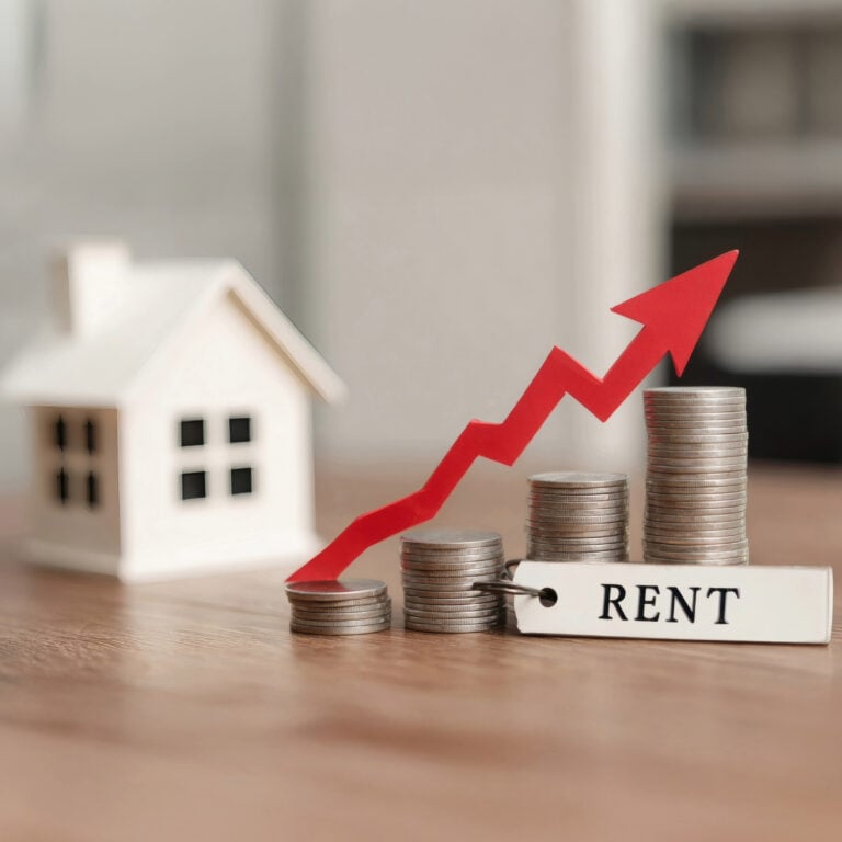 Rising rents illustrated by stacked coins and upward red arrow beside a model house