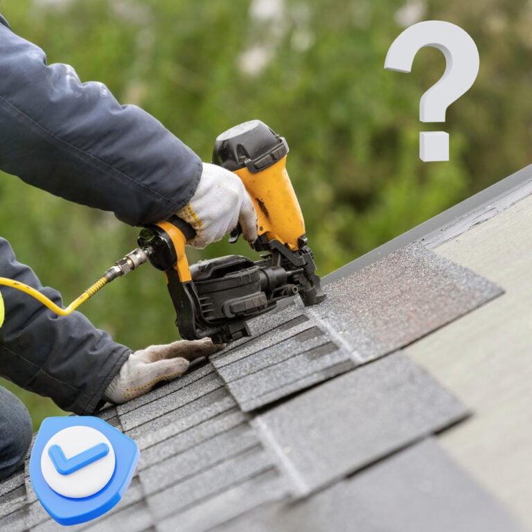 Roofer using a nail gun to replace roof tiles on a London home in a conservation area