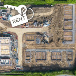 Aerial view of housing construction site with foundations and a key labelled “rent,” representing Build-to-Rent housing development