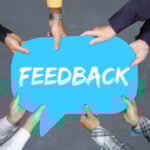 Hands holding a blue speech bubble with the word “Feedback,” symbolising public consultation on private renting policies.