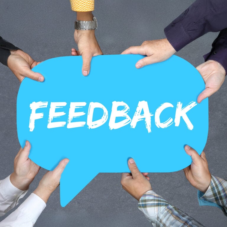 Hands holding a blue speech bubble with the word “Feedback,” symbolising public consultation on private renting policies.