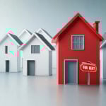 Red house with a “for rent” sign among white homes symbolising UK rental market pressures