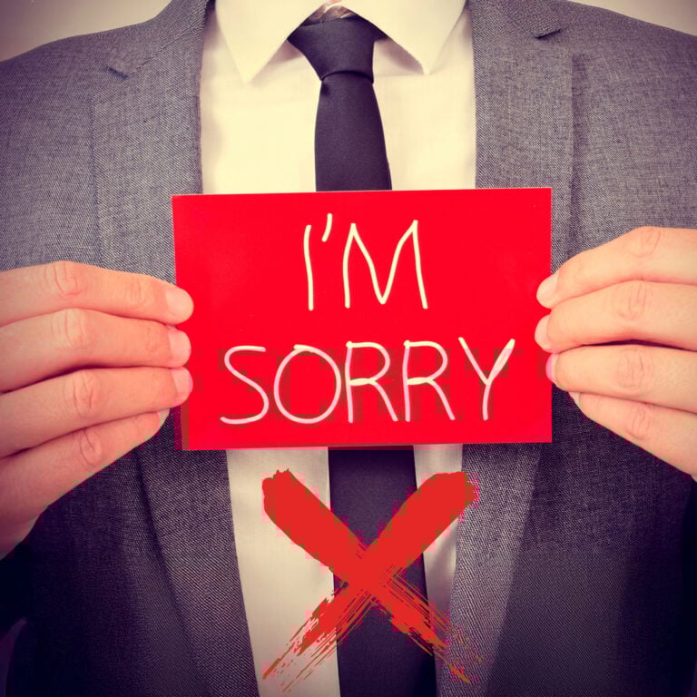 Businessperson holding “I’m Sorry” sign highlighting need for stronger apologies in social housing complaints
