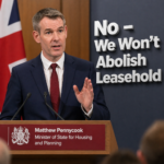 Housing minister Matthew Pennycook speaking at podium on leasehold reform policy