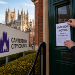 Eviction notice being fixed to a front door near Canterbury City Council offices