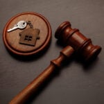 Judge’s gavel beside house key symbolising landlord possession and eviction proceedings